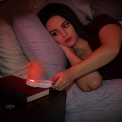 Woman using the TrueLight Luna Red Nightlight and Flashlight